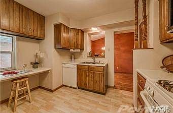 Kitchen with breakfast bar and leading to the dining room.