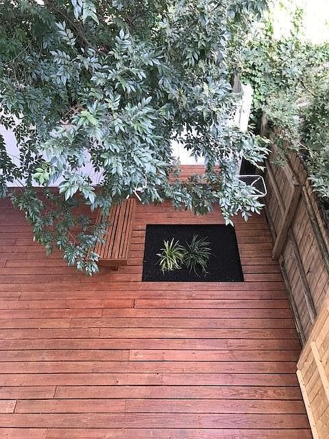 Private Decked back yard with benches, shade & planting spac