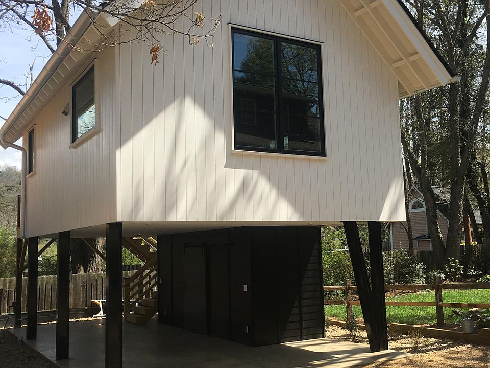 Carport with adjacent storage under living space.