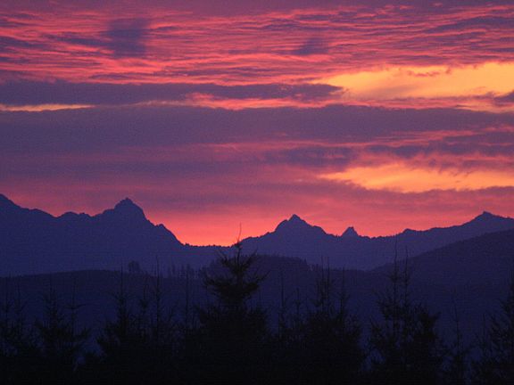 view of the sun rising over the Cascades