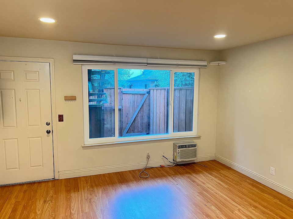 Front window overlooking a small outdoor space