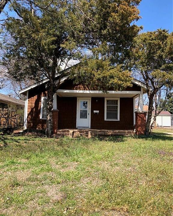 Charming Cottage with front porch, concrete storage building, covered RV  parking in back and large shop that is insulated, with electricity that was used for a wood working shop. Back alley access for shop and RV shelter.