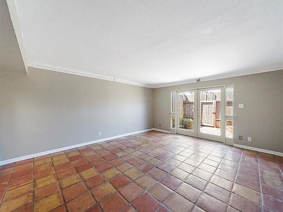 Living area has plenty of natural light and leads to outdoor patio.