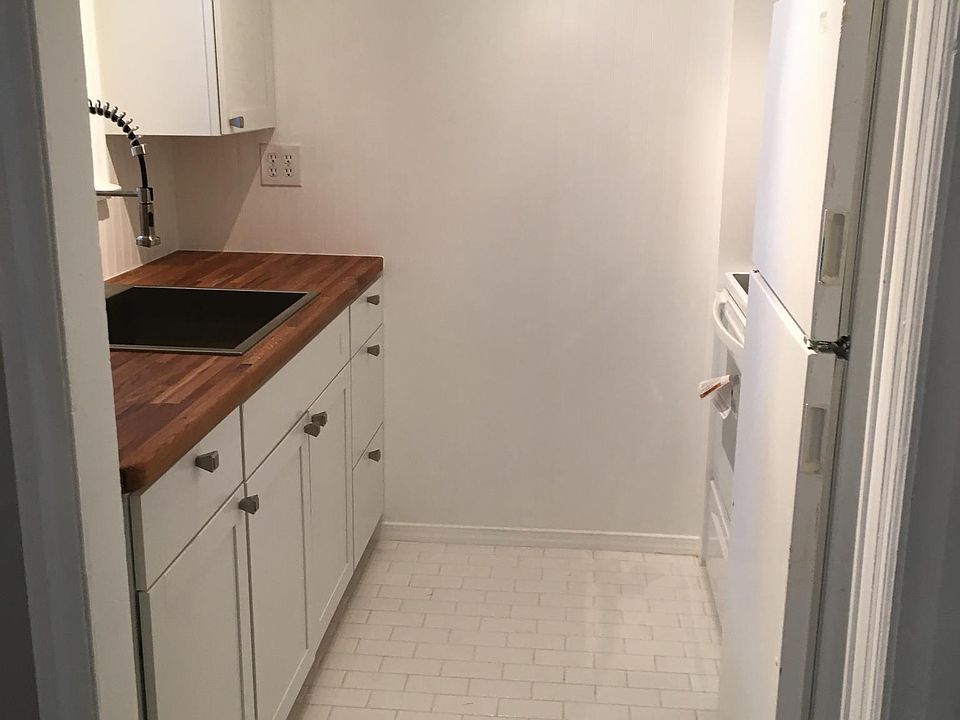 White subway tile with new cabinets, sink, faucet