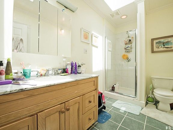 Top Unit - Spacious full bathroom with skylights. Separate tub and shower.