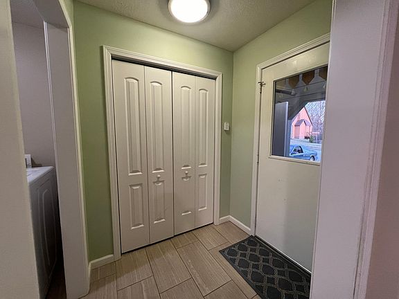 Mud room and closet with door leading to garage.