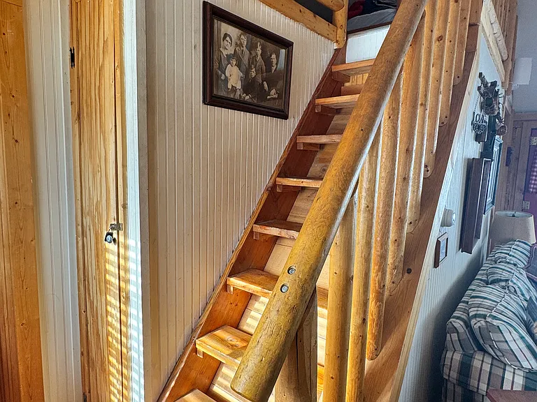 Non conforming stairs to upper 3rd bedroom and red and blue twin beds loft open to family room