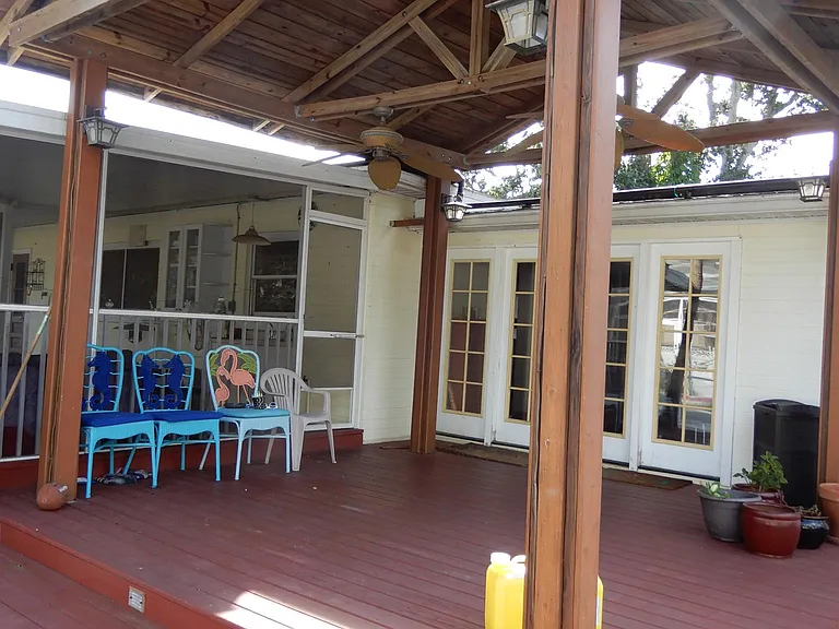 Exterior view of gazebo, raised wood deck, exterior french doors and entrance to screened porch.