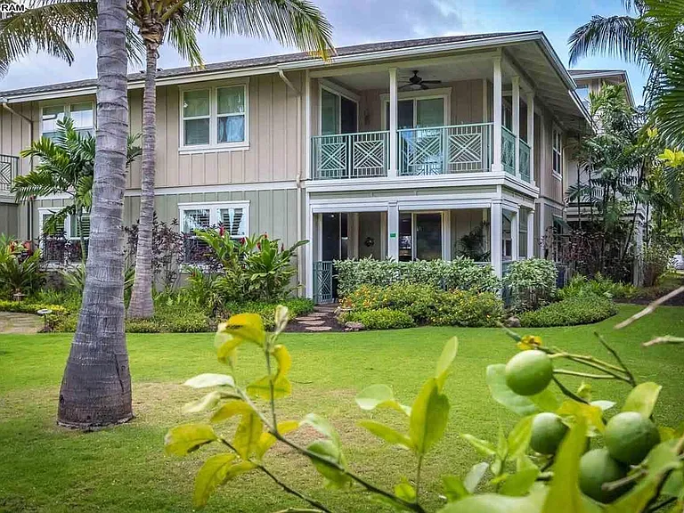 Long view of our lanai with stepping stones leading out onto the back gardens. Kumquats in the foreground.