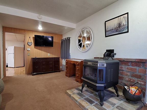 Living room partially furnished with BRAND NEW PELLET STOVE (Tenant responsible for operation/maintenance).