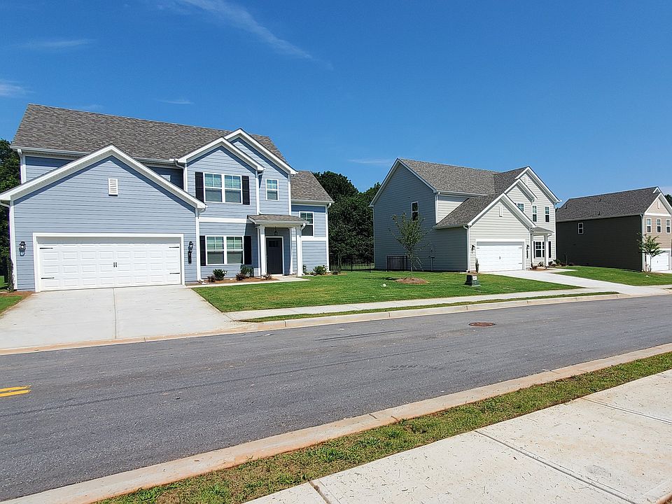 Exterior shot of the two story homes with private driveways and attached garages.