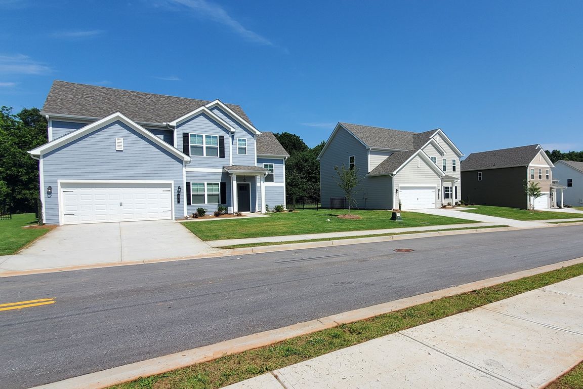 Exterior shot of the two story homes with private driveways and attached garages.