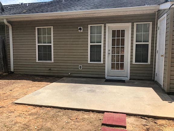 Fenced in back yard with patio