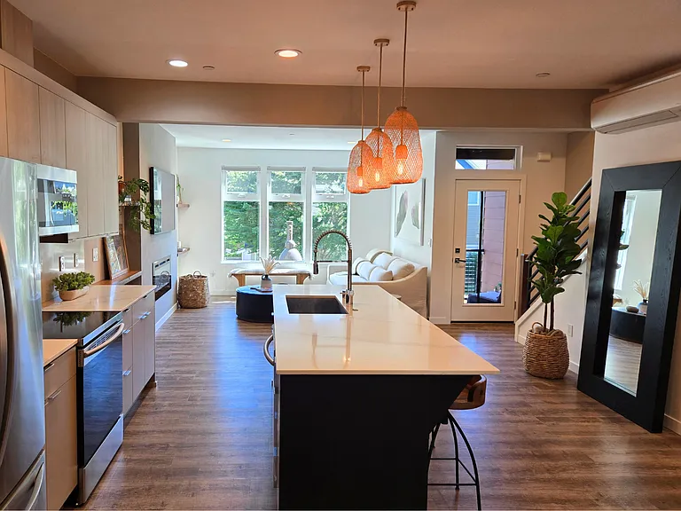 Bright and open living space with South facing windows and greenery