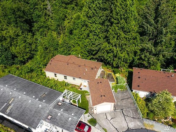 One car garage and extra parking - House is tucked below and away from neighbors. Newer roof!