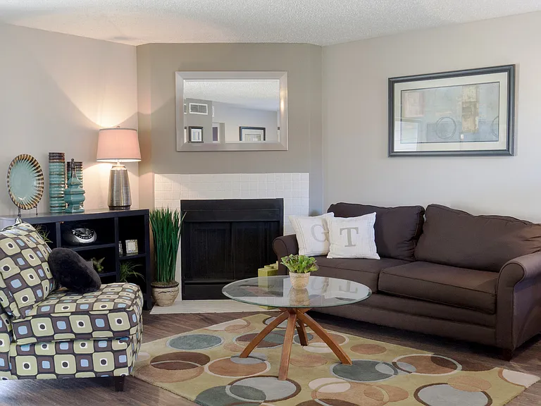 Welcoming Living Room with Fireplace in Carrollton, TX Apartments