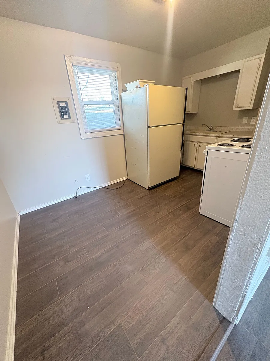 Kitchen with refrigerator and cabinet storage - 314 N Hedgecoke St
