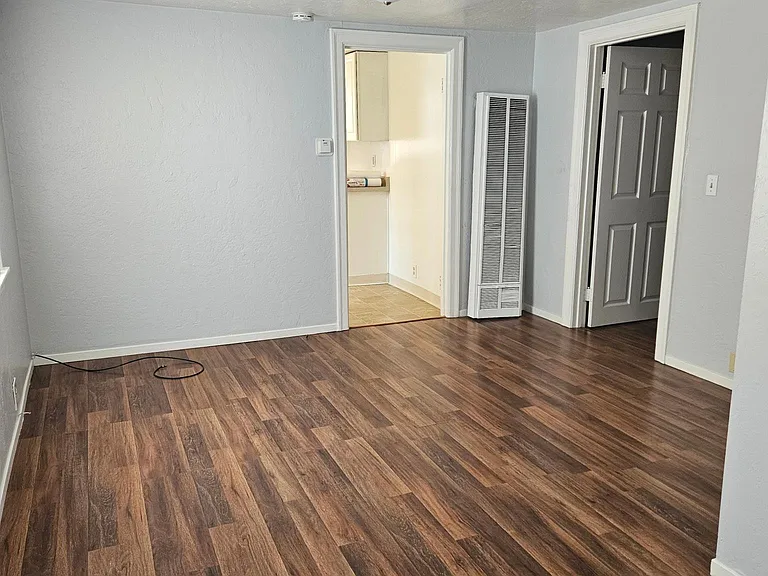 Living area, looking toward kitchen and bedroom door.