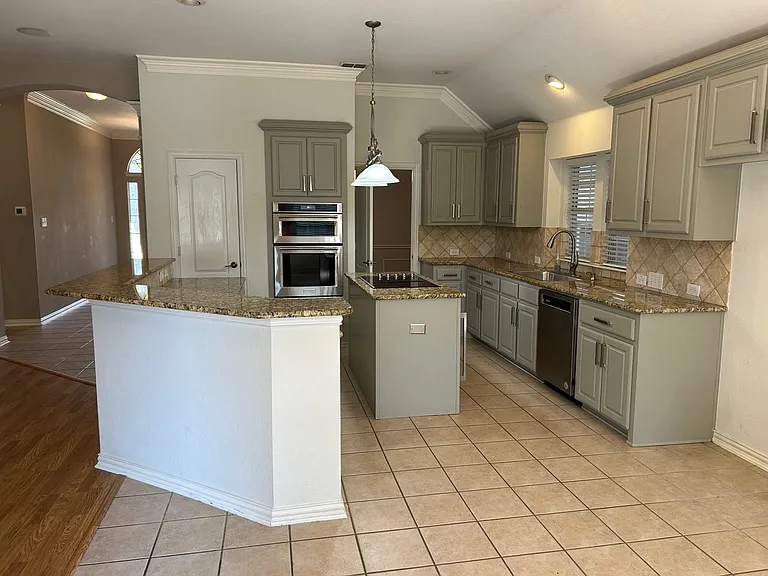 Chef's kitchen with granite and plenty of kitchen cabinets.