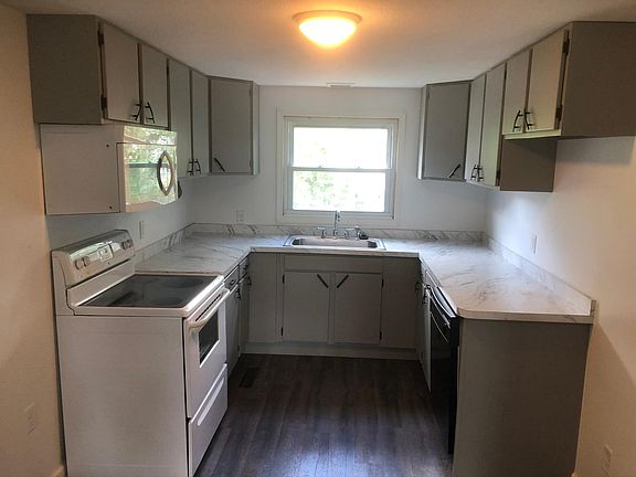 Kitchen. All updated appliances and refinished cabinetry. Includes garbage disposal, range, microwave, and dishwasher. Brand new counter top and sink.