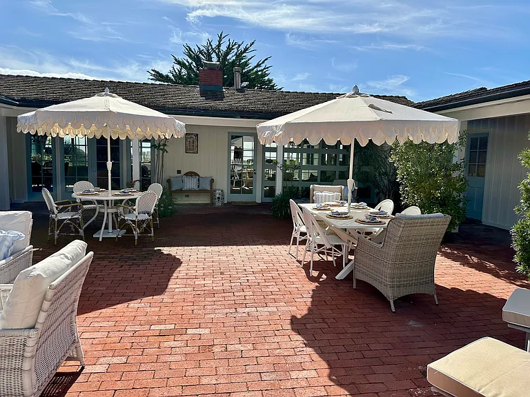 Front courtyard with front door in the background. As you enter into the lanai you will see the ocean through the back windows.