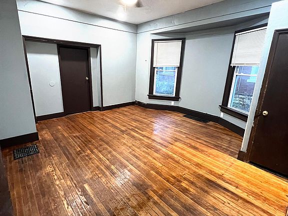 View of living room, looking toward bedroom door