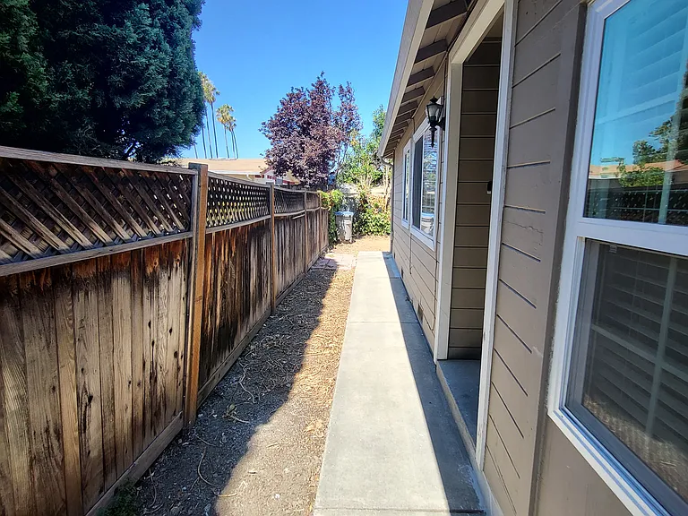 Beyond Privacy Gate leading to entrance door and back yard.