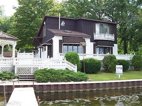 This home has 137' of private lake frontage on all sports Duck Lake, with 3 bedrooms,2 full baths, Oak kitchen, Living room with all brick fireplace, formal dining, plus an eat in kitchen. there is a lot of Corian counter tops in Kitchen and bath. The upstairs is all master suite, vaulted ceilings, sky lights, and  a wonderful view of the lake, there are several large Bow windows in this home, so the views  of the lake are great. wrap around deck in front and on the side of the house. This house is Ready to move into, just take a look at the pictures and call Sharon today