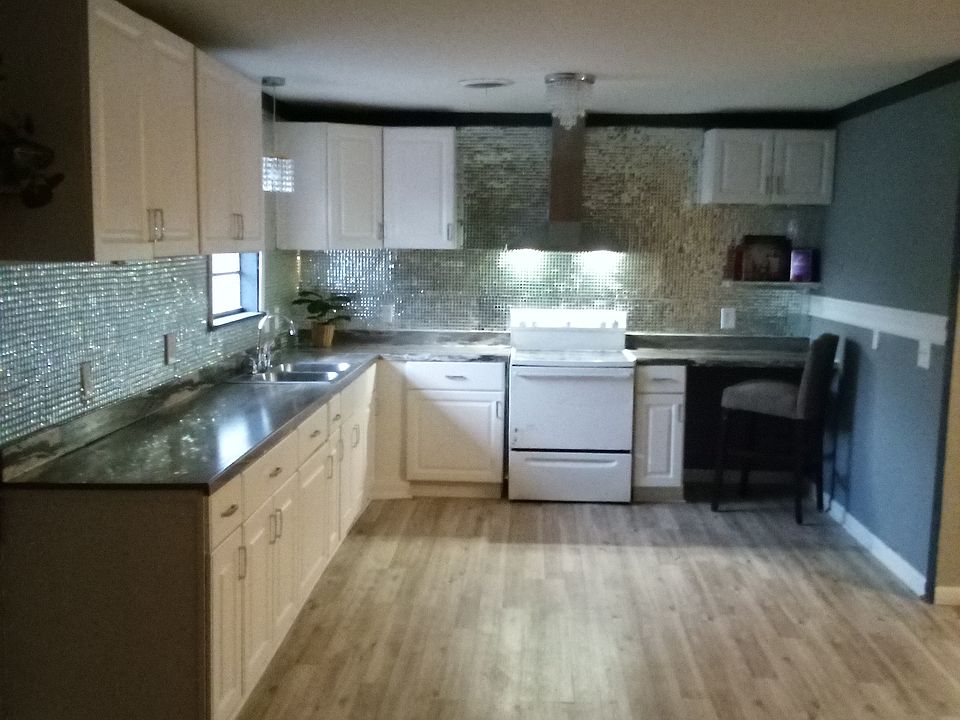 Beautiful Open concept Kitchen, 
Elegant Real Glass Backsplash adding Upgraded Elegance, under cabinet remote control lights , small cocktail floating bar, faculour Hood vent, Elegant chandelier Lightings .
A Kitchen with expensive , elegant taste .