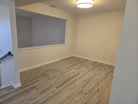 The formal dining room connects to the kitchen and is open to the large living room below.