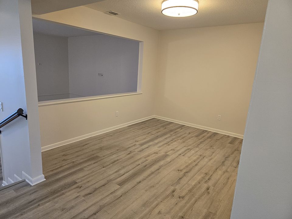 The formal dining room connects to the kitchen and is open to the large living room below.