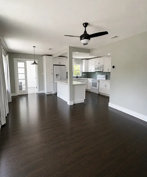 Open-concept living room layout that flows into the kitchen and dining/breakfast area.