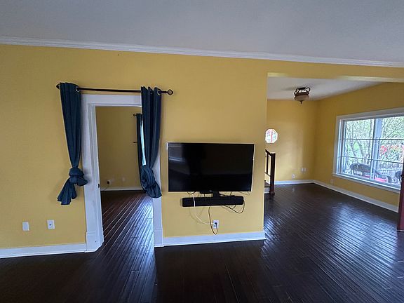 Doorway of first floor bedroom (left) and living room / staircase nook (right)