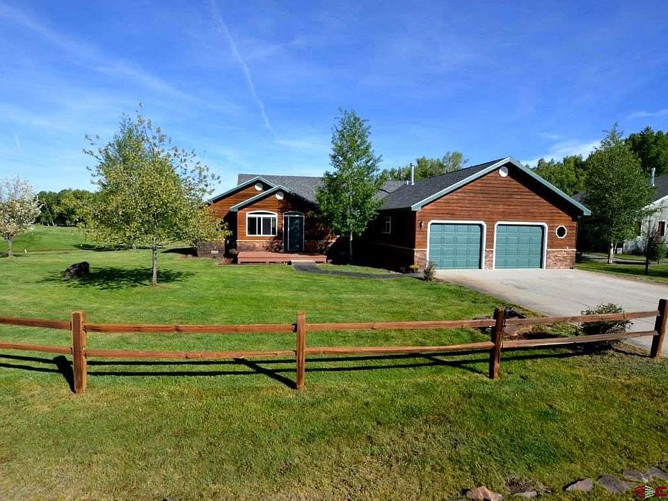 Ranch style home, manicured lawns, mature trees, on Dos Rios Golf Course