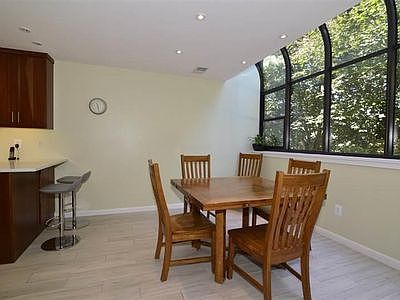 Another view of the dining areas, the high-ceilings and window, and radiant-heated porcelain tile floors,