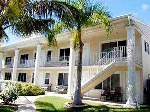 Outside building. Unit ground floor on right.