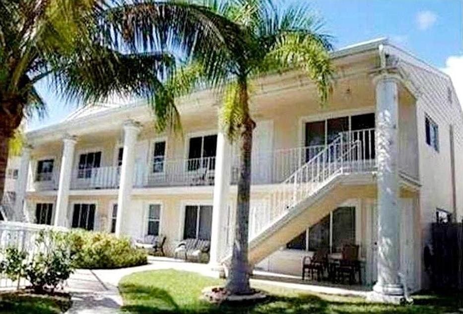 Outside building. Unit ground floor on right.