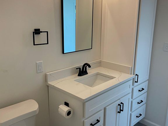 First floor full bathroom includes new tub shower with white subway tile.