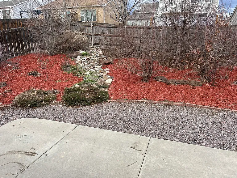 Back yard xeriscape with river bed