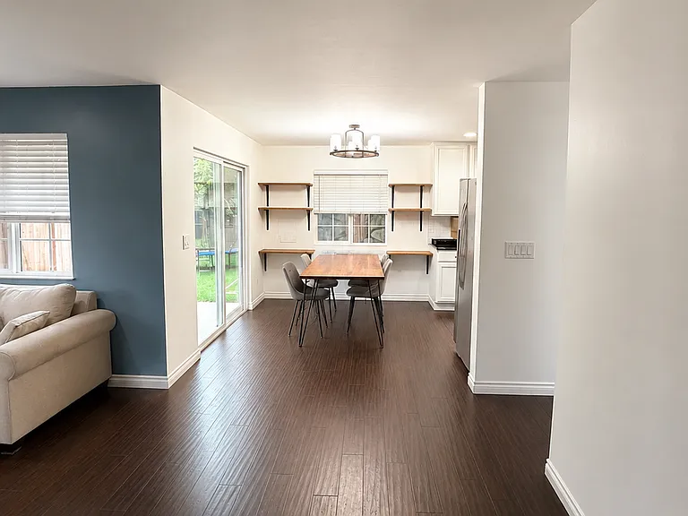 Dining space, with sliding back doors to the fully fenced backyard.