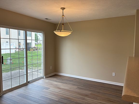Dining area with sliding glass door to rear patio.