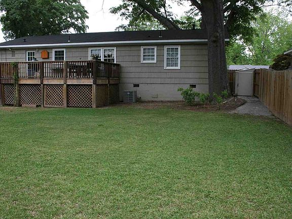 Large flat yard surrounded by 6 foot wooden privacy fence