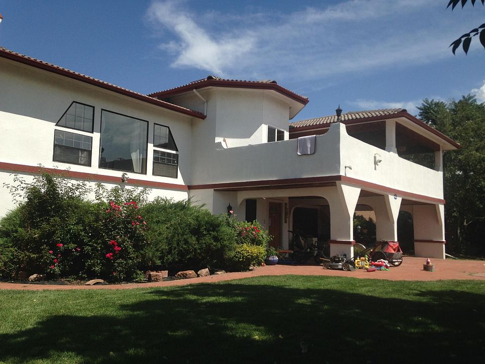Nice rose bushes and lush green lawn out front.