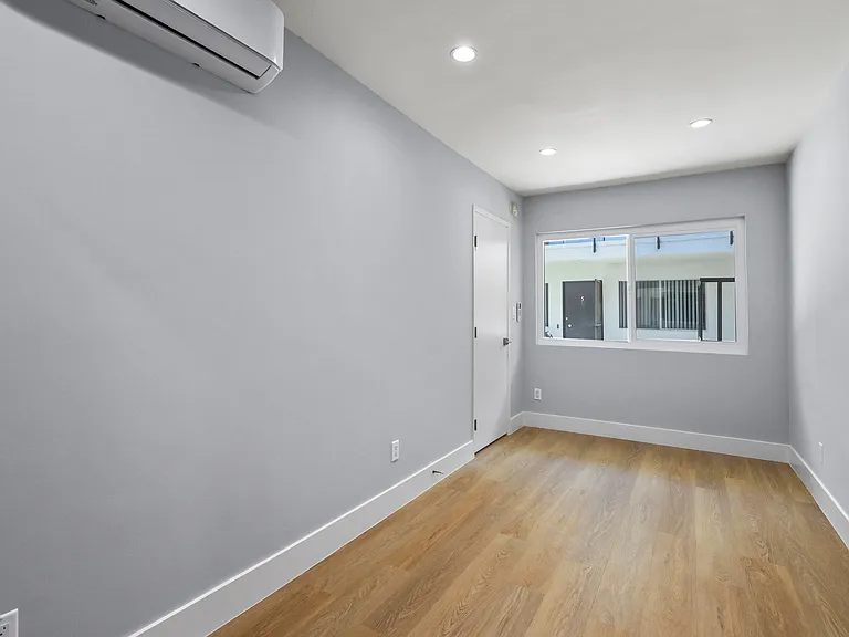 Bedroom with Large Windows, Vinyl Flooring, and Recessed Lighting