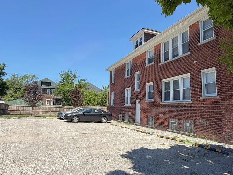 Private parking area - two cars per unit permitted. Note the side door entrance, most commonly used by tenants in east side units (including 2440).
