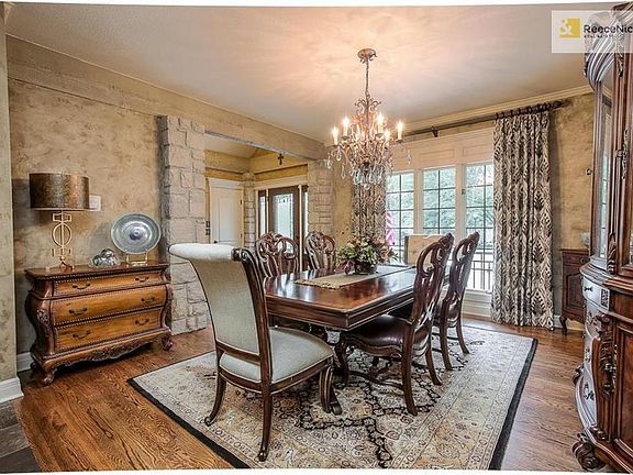 The stone continues inside with this stately dining room with stone accents