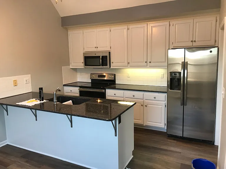 Kitchen with Granite and stainless- steel appliances.
