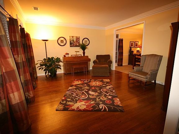 Living Room with crown and dentil molding, hardwood floors and transom windows
