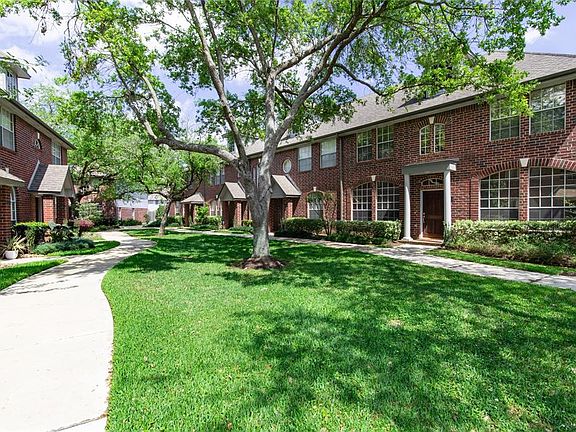 The home is located in a quiet community with mature trees and extensive landscaping.