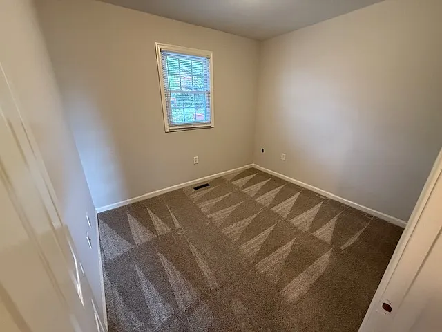 Second bedroom, new carpet, freshly painted, one closet.